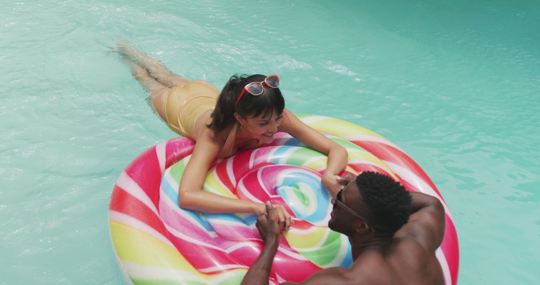 Couple Relaxing in Pool with Colorful Inflatable Raft - Free Images, Stock Photos and Pictures on Pikwizard.com