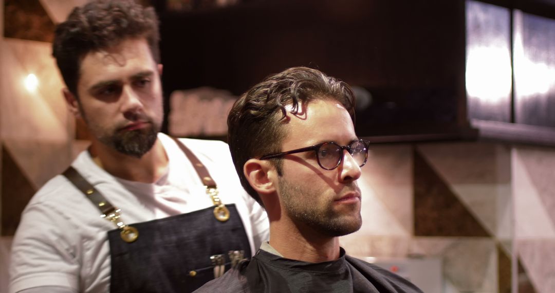 Man Getting Haircut at Modern Barbershop with Barber in Background - Free Images, Stock Photos and Pictures on Pikwizard.com