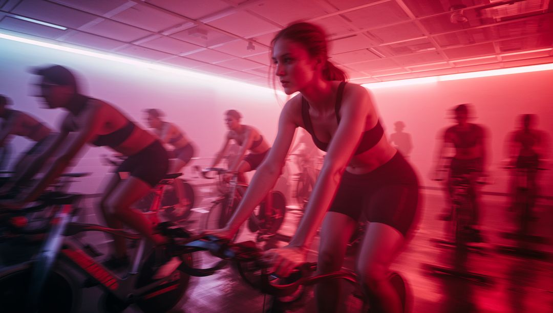 Intense Spin Class with Neon Lights and Focused Cyclists