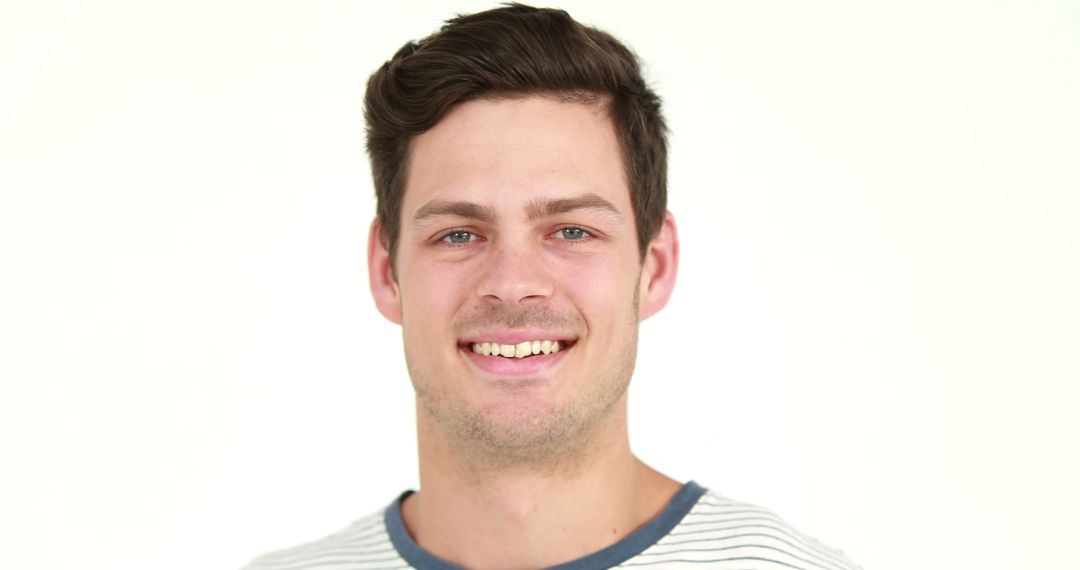 Young Man Smiling with Casual Outfit Against White Background - Free Images, Stock Photos and Pictures on Pikwizard.com