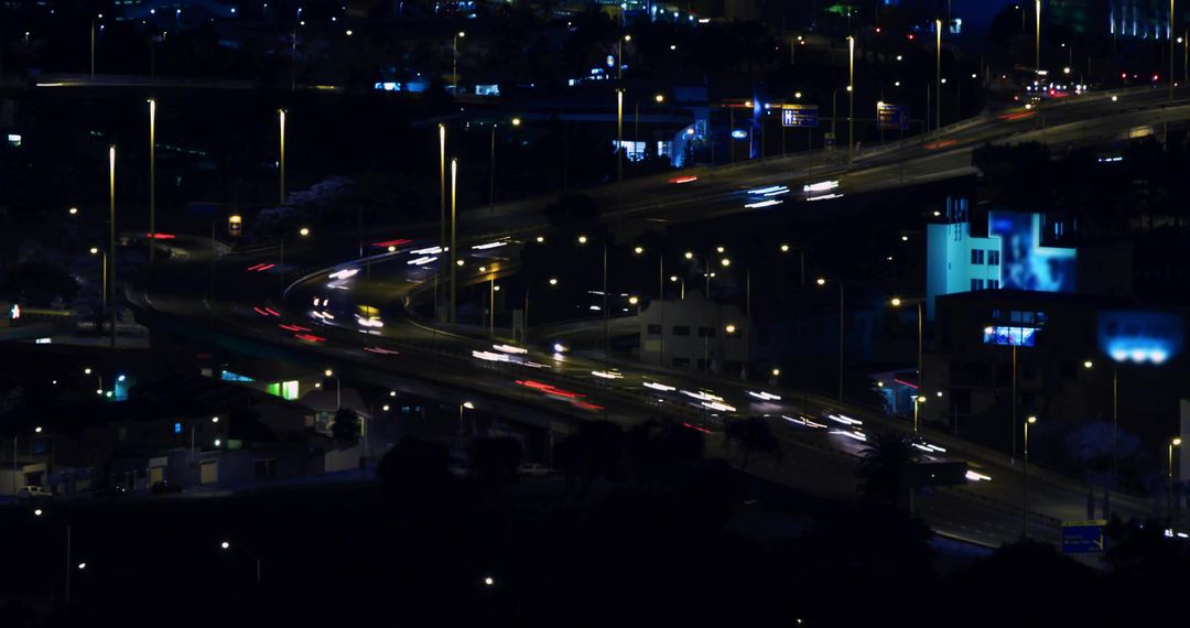 Curved Highway Interchange with Light Trails at Night