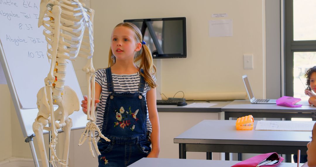 Young Student Presenting Human Skeleton in Class