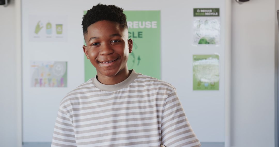 Young Student Presenting Recycling Display in Classroom