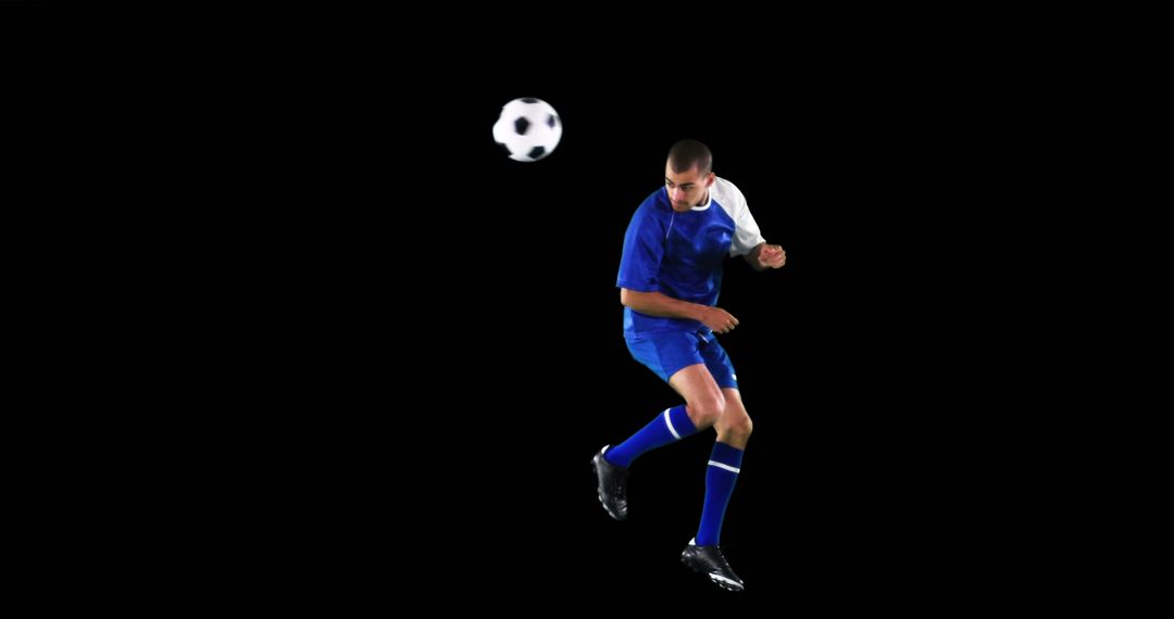 Soccer Player Heading Ball on Isolated Black Background - Free Images, Stock Photos and Pictures on Pikwizard.com