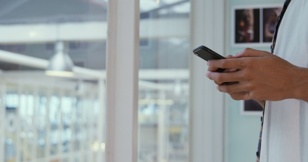 Person Using Smartphone in Modern Office Environment - Free Images, Stock Photos and Pictures on Pikwizard.com