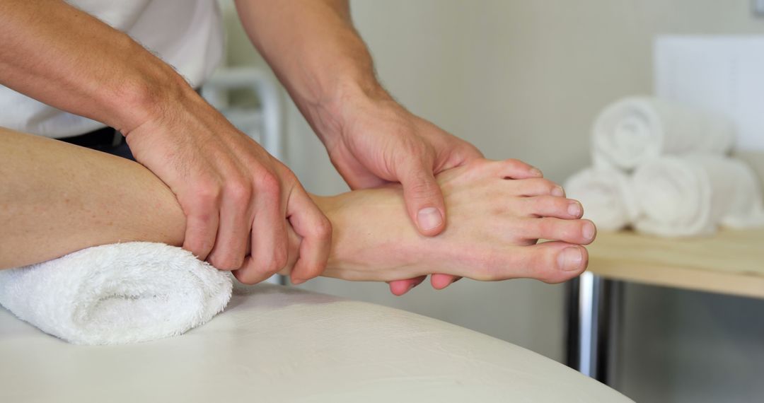 Physiotherapist treating patient foot massage therapy - Free Images, Stock Photos and Pictures on Pikwizard.com