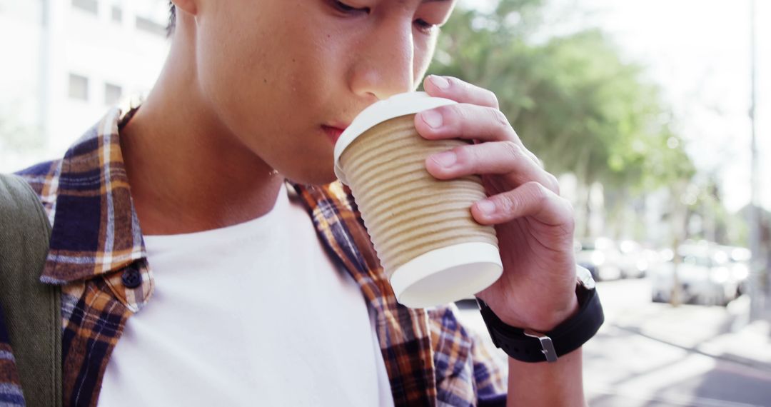 Casual Young Man Drinking Coffee Outdoors - Free Images, Stock Photos and Pictures on Pikwizard.com