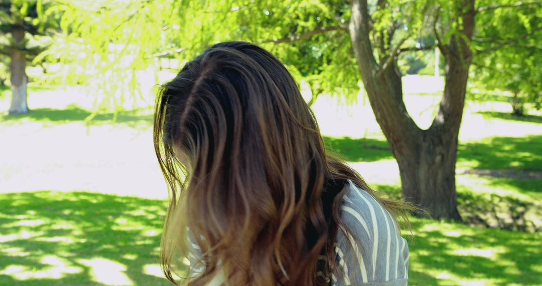 Long Brown Hair in the Breeze in a Sunny Park - Free Images, Stock Photos and Pictures on Pikwizard.com