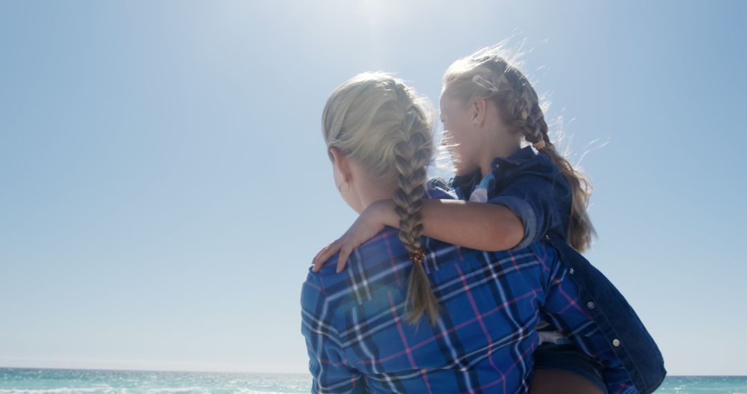 Mother and Daughter with Braided Hair Enjoying Beach View - Free Images, Stock Photos and Pictures on Pikwizard.com