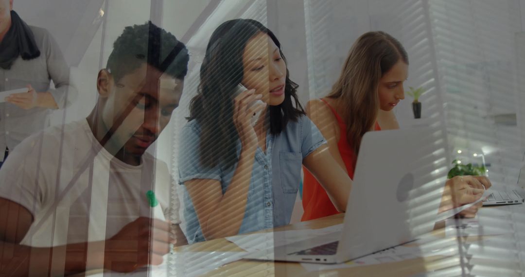 Diverse Team Collaborating with Digital Tools in Modern Office