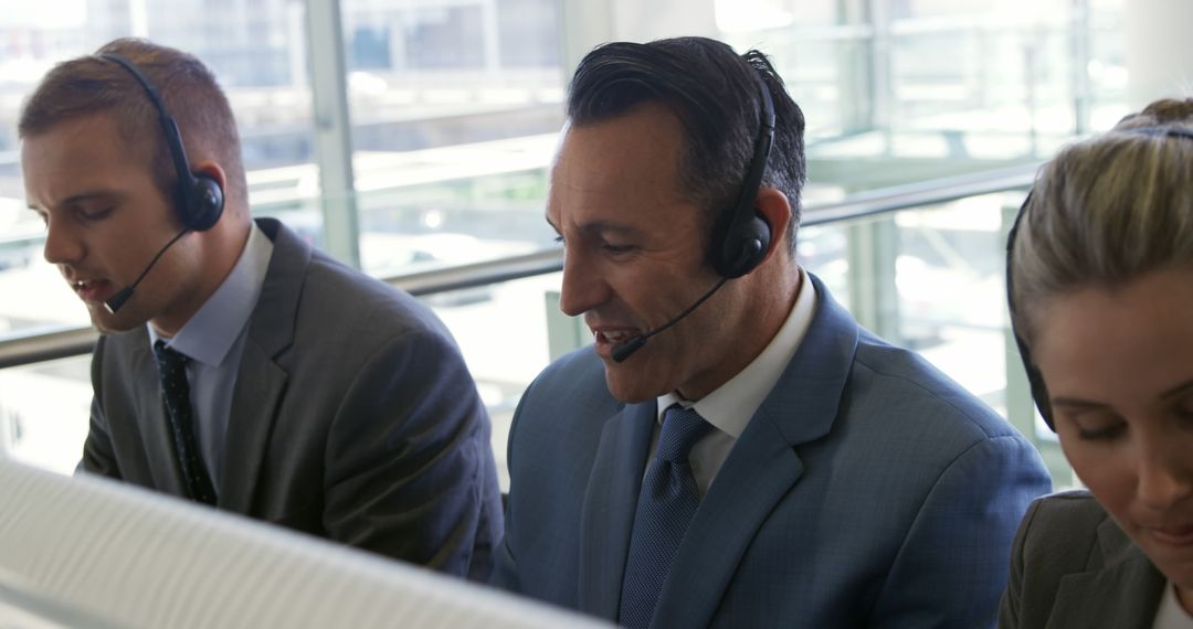 Customer Service Representatives Working with Headsets in Office - Free Images, Stock Photos and Pictures on Pikwizard.com