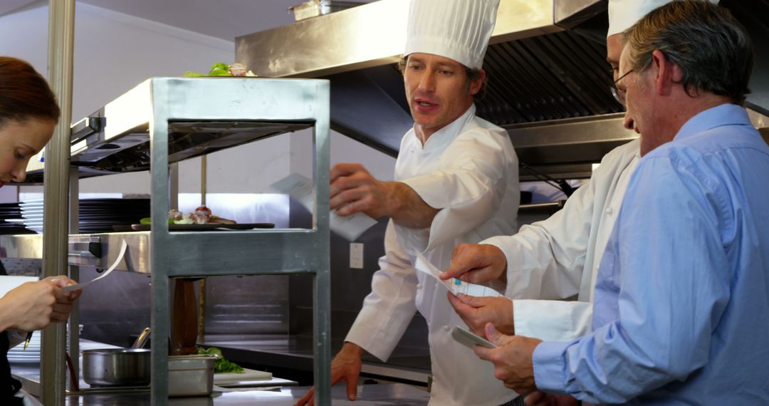 Restaurant Manager Overseeing Chefs in Busy Kitchen