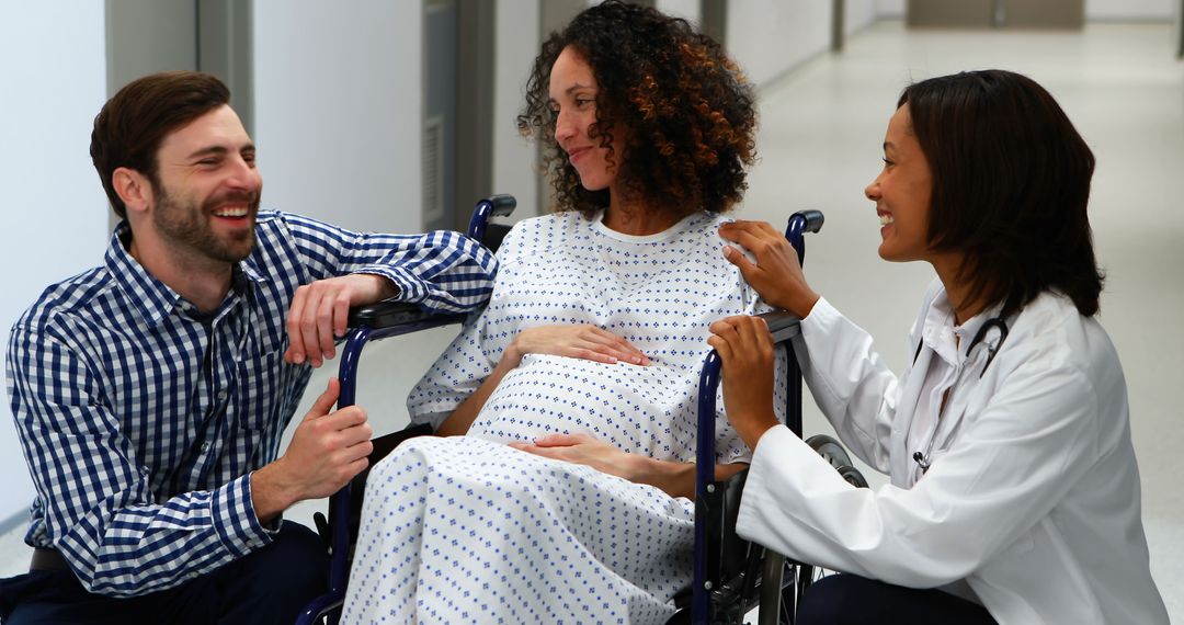 Pregnant Woman in Wheelchair with Partner and Doctor in Hospital - Free Images, Stock Photos and Pictures on Pikwizard.com