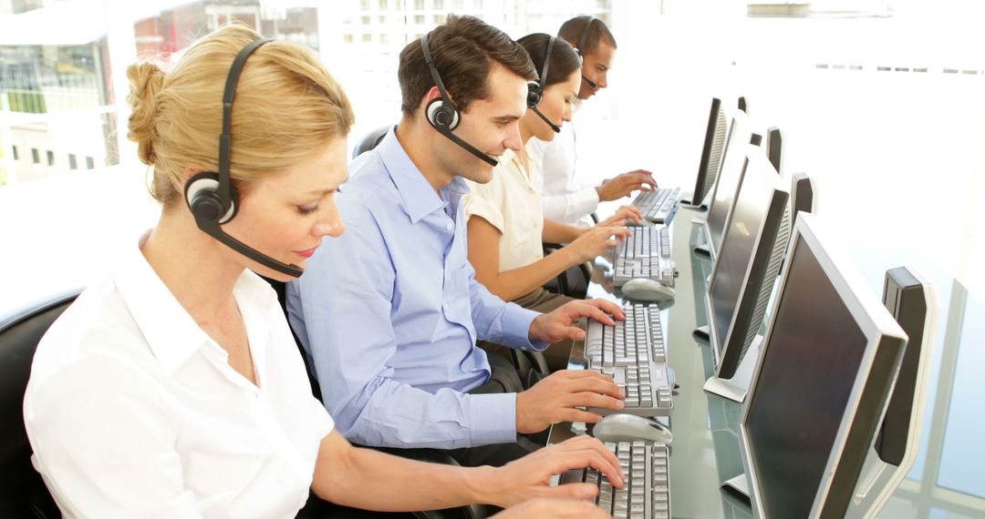 Customer Service Team Working at Desks in a Call Center - Free Images, Stock Photos and Pictures on Pikwizard.com