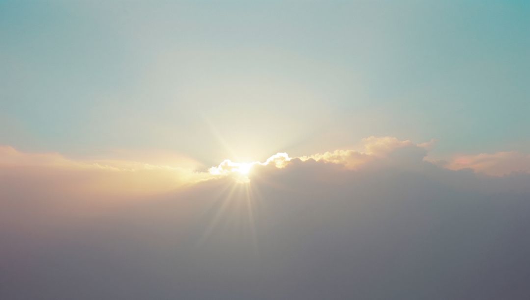 Serene Sunrise With Sunburst Over Soft Cloud Horizon