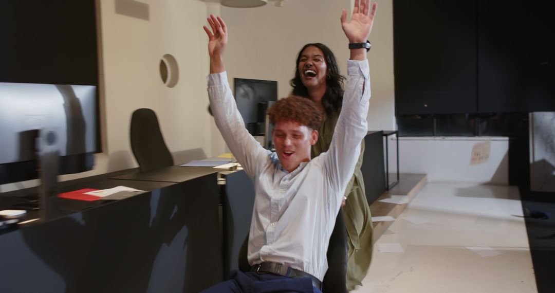 Diverse Colleagues Enjoying Office Pranks in Modern Workspace