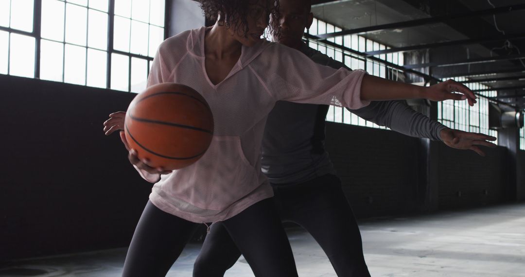 Two Athletes Playing Basketball Indoors in Dramatic Lighting - Free Images, Stock Photos and Pictures on Pikwizard.com