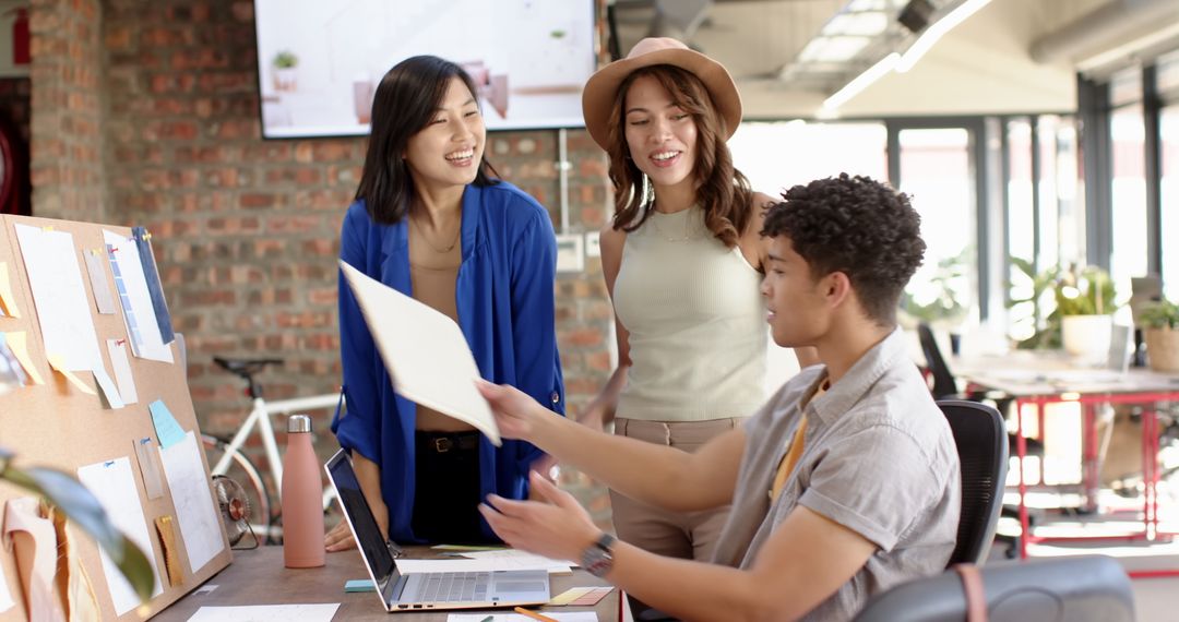Diverse Team Collaborating in Modern Open-Plan Office Essential for New Ideas