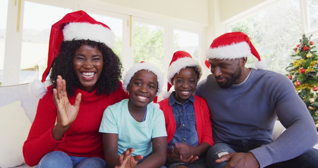 Festive Family Celebration with Santa Hats and Joyful Smiles - Free Images, Stock Photos and Pictures on Pikwizard.com