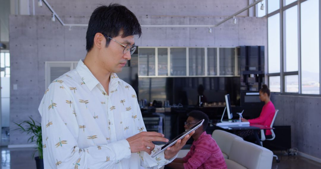 Asian Executive Using Tablet in Contemporary Workspace