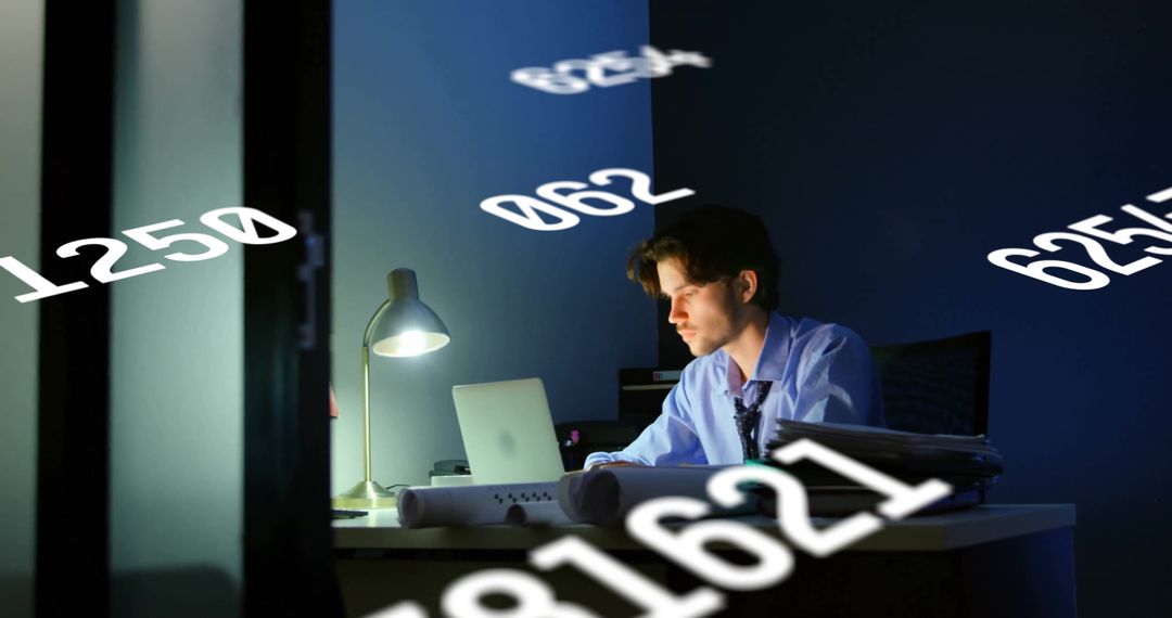 Businessman Analyzing Data on Laptop in Dim Office