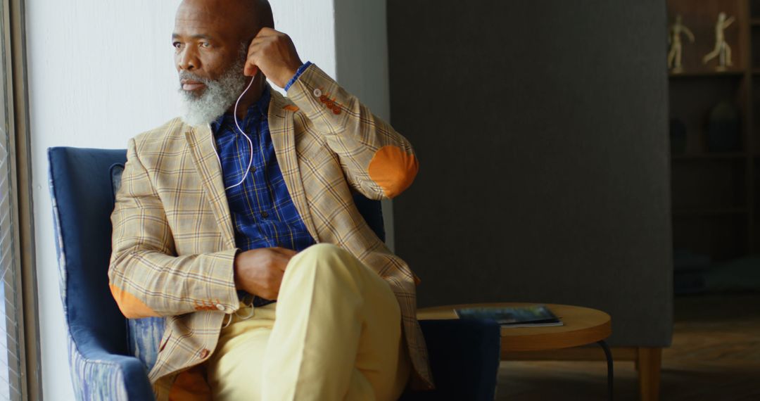 Stylish Senior Man Contemplating Life in Elegant Seating - Free Images, Stock Photos and Pictures on Pikwizard.com