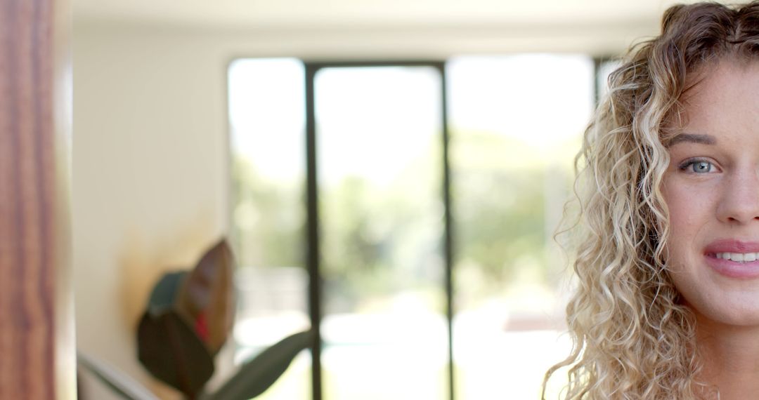 Portrait of Young Woman with Curly Hair in Modern Home Interior - Free Images, Stock Photos and Pictures on Pikwizard.com