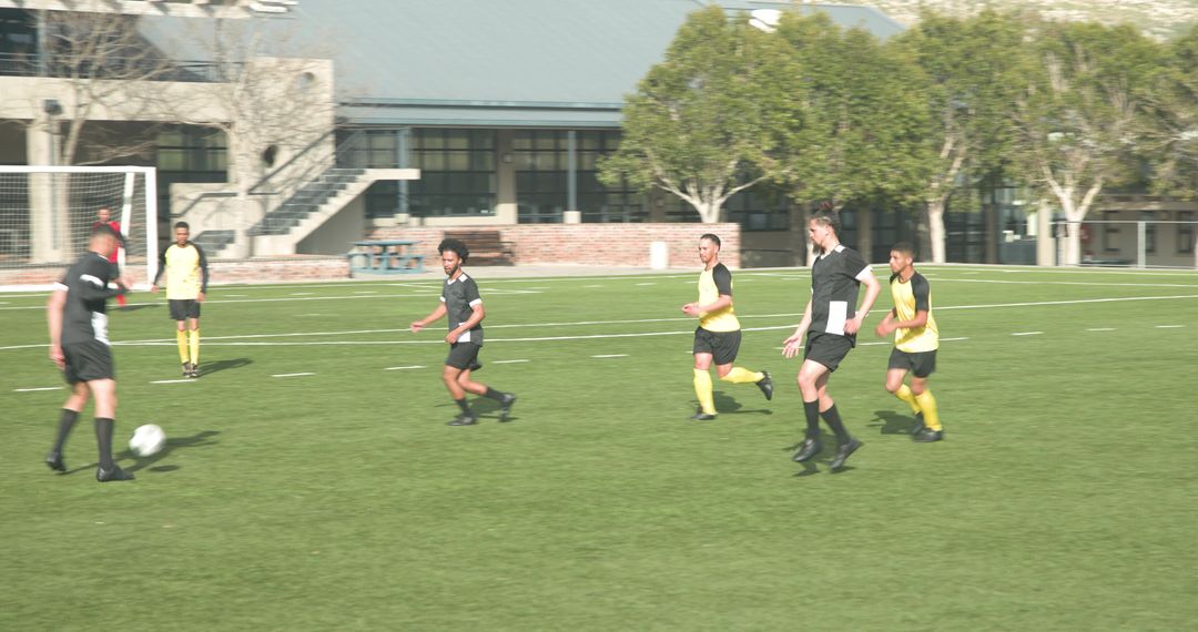 Soccer Players Displaying Teamwork on Field During Match