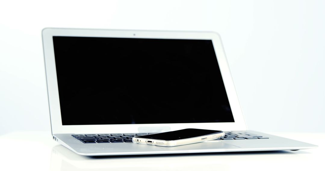 Close-up of laptop and mobile phone against white background 4k - Free Images, Stock Photos and Pictures on Pikwizard.com