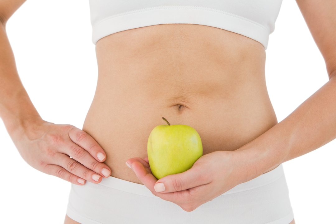 Transparent background fit woman holding green apple to abdomen promoting healthy eating - Download Free Stock Images Pikwizard.com