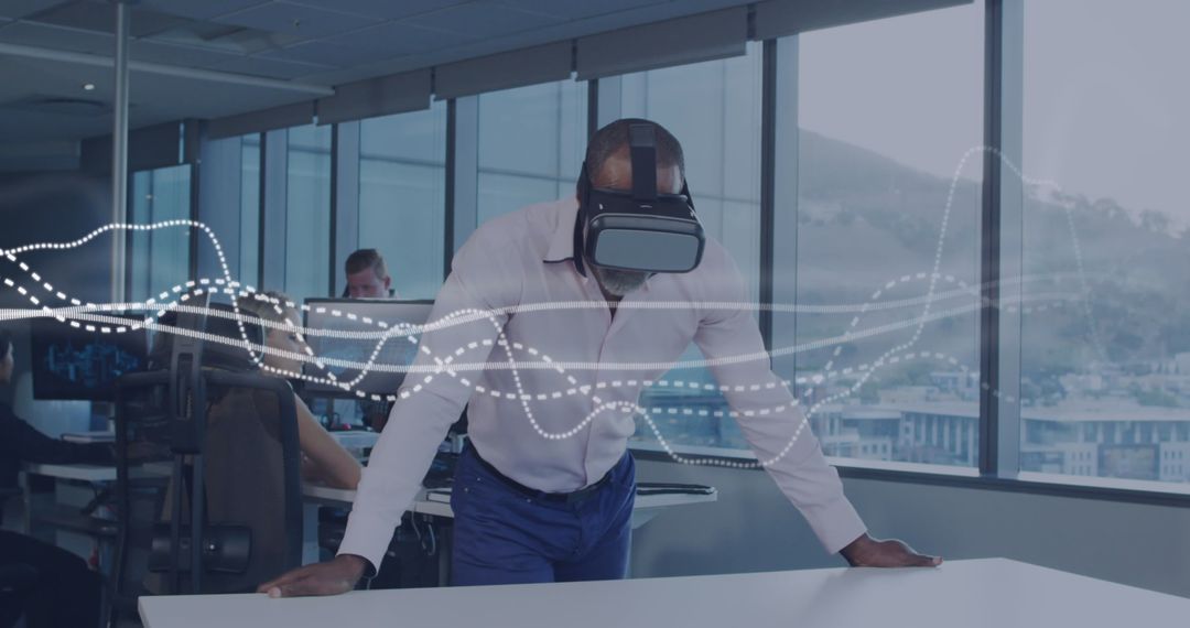 Businessman Using VR Headset for Data Visualization in Modern Office