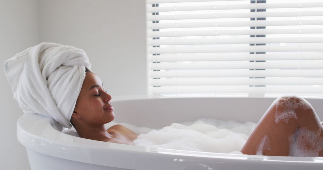 Woman Relaxing in Bathtub with Towels and Bubbles - Free Images, Stock Photos and Pictures on Pikwizard.com