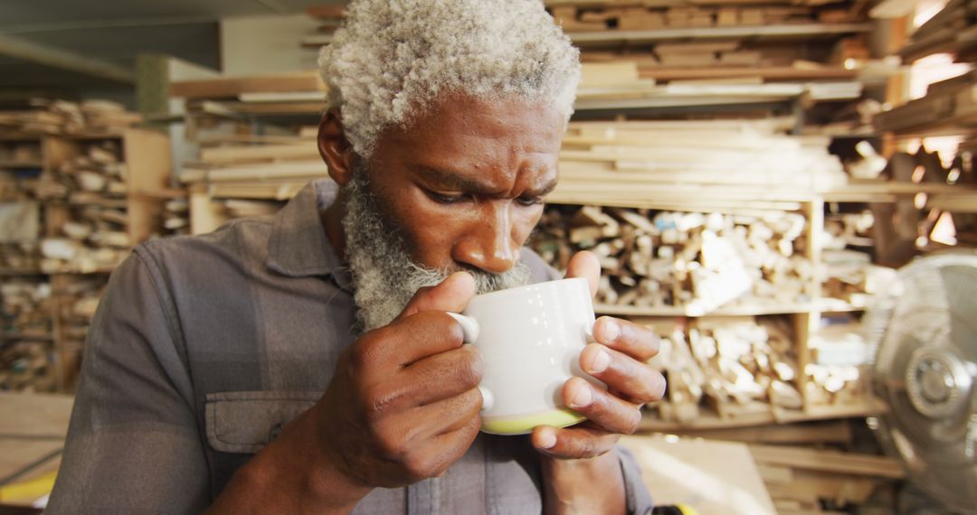 Senior Woodworker Enjoying Hot Drink in Cozy Workshop - Free Images, Stock Photos and Pictures on Pikwizard.com