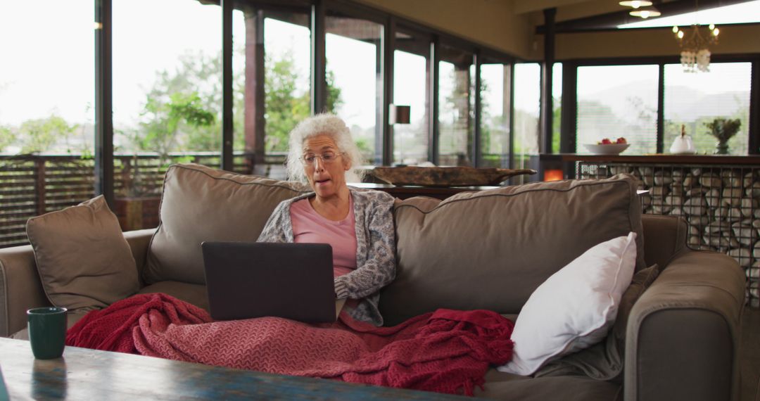 Elderly Woman Using Laptop in Modern Mountain Home - Free Images, Stock Photos and Pictures on Pikwizard.com