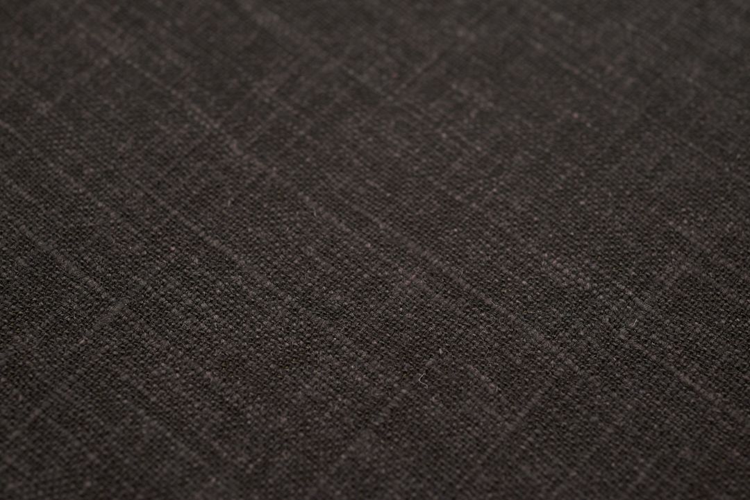 Dark charcoal linen texture with subtle crosshatch weave for rustic modern backgrounds