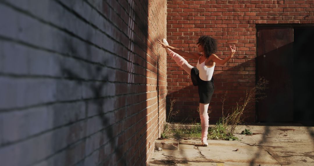 Ballet Dancer Exercising Near Brick Wall Outdoors - Free Images, Stock Photos and Pictures on Pikwizard.com