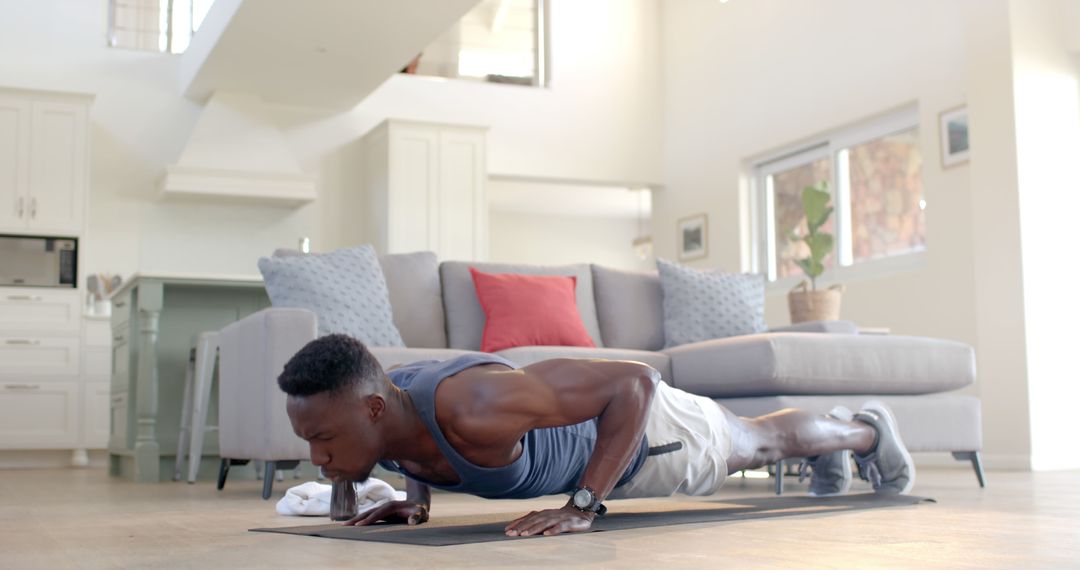 Young Man Doing Push-Ups in Modern Living Room - Free Images, Stock Photos and Pictures on Pikwizard.com