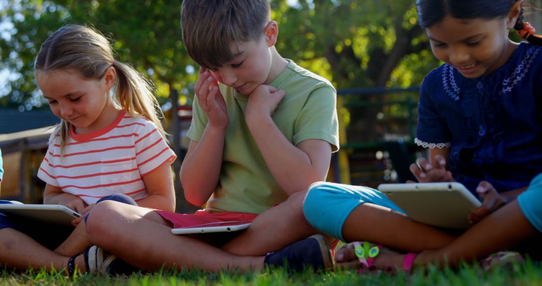 Group of Children Learning on Tablets in Outdoor Park - Free Images, Stock Photos and Pictures on Pikwizard.com