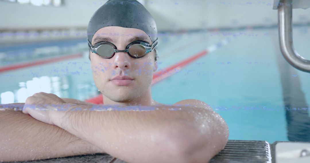 Swimmer Resting at Pool Edge with Goggles and Swim Cap