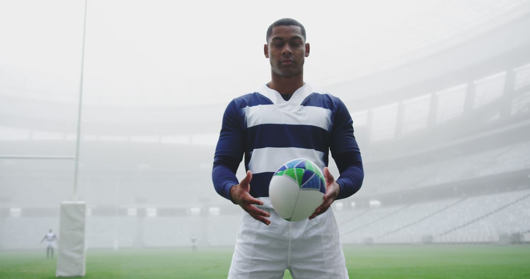 Rugby Player Holding Ball on Foggy Stadium Field - Free Images, Stock Photos and Pictures on Pikwizard.com