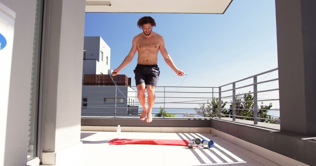 Man exercising with skipping ropes in balcony at home 4k - Free Images, Stock Photos and Pictures on Pikwizard.com