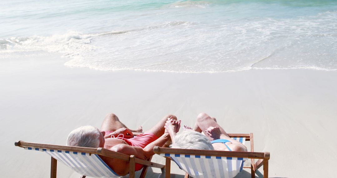 Senior Couple Enjoying Beach Vacation Relaxing on Lounge Chairs - Free Images, Stock Photos and Pictures on Pikwizard.com