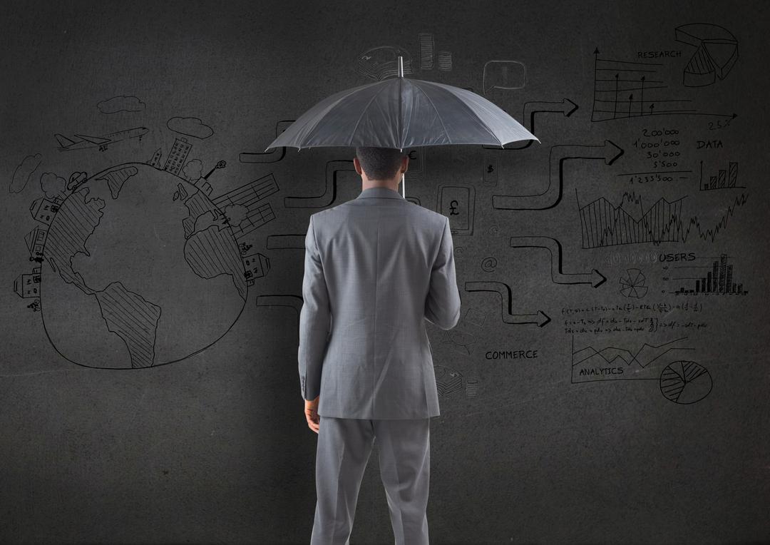 Businessman holding an umbrella against business plan sketch on blackboard - Free Images, Stock Photos and Pictures on Pikwizard.com