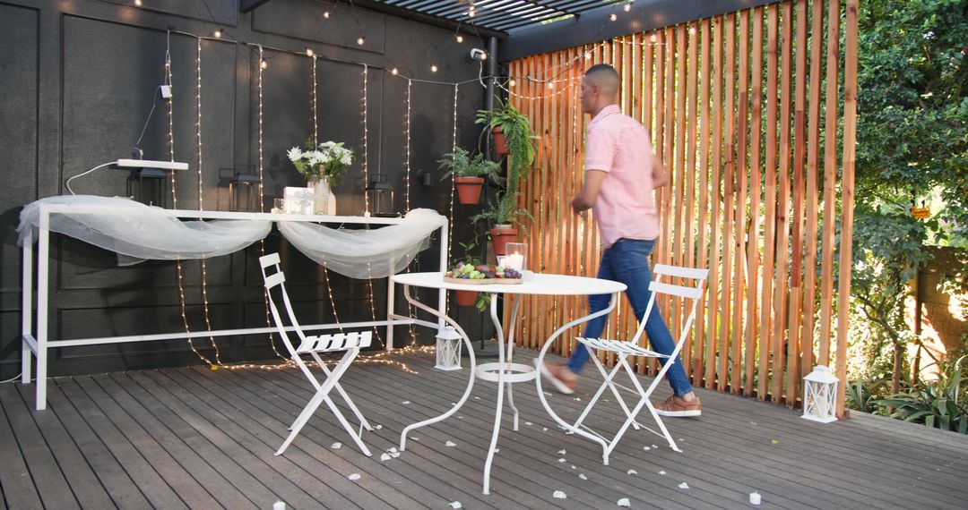 Man Creating Romantic Atmosphere on Cozy Patio