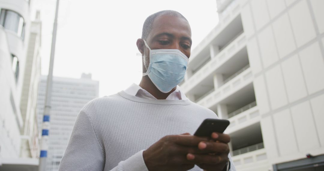 Man Wearing Face Mask Using Smartphone in Urban Environment - Free Images, Stock Photos and Pictures on Pikwizard.com