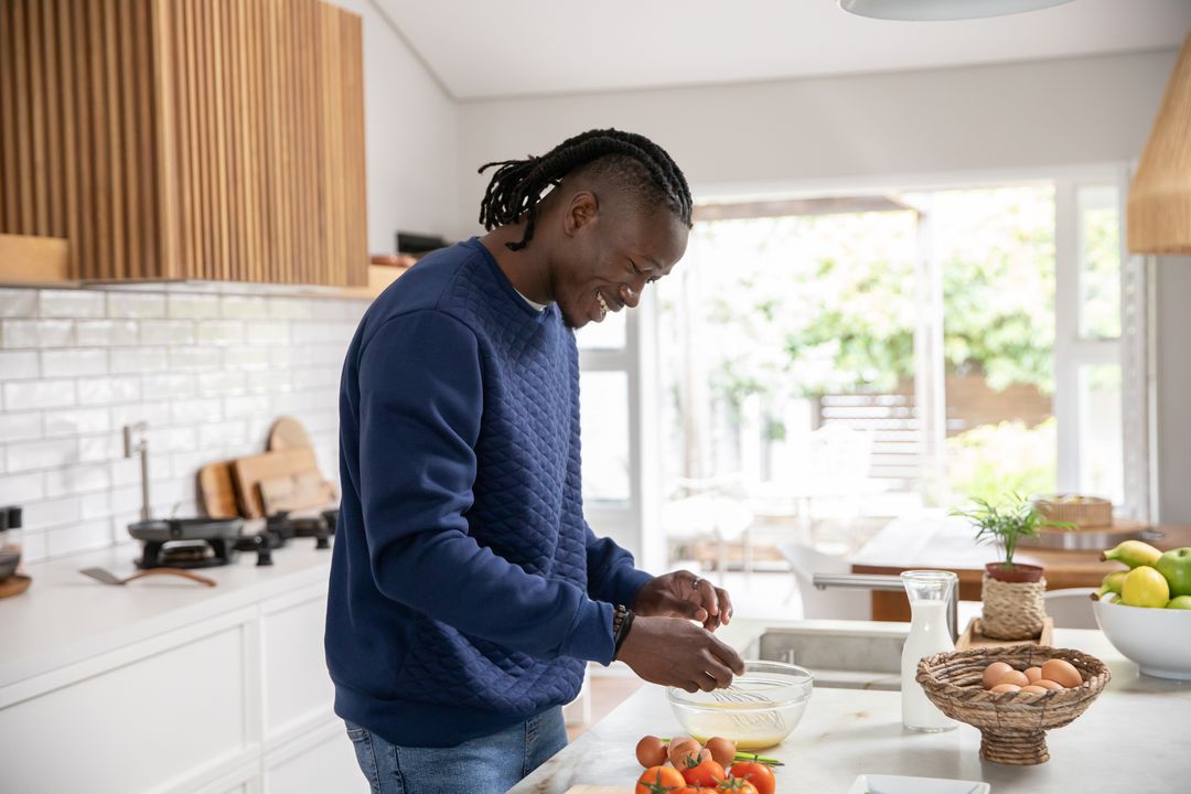 Man Whisking Eggs in Modern Kitchen