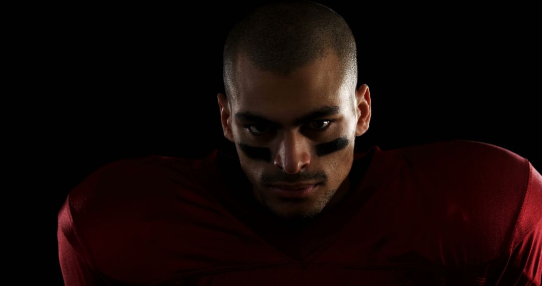 Determined Football Player in Red Jersey Focused - Free Images, Stock Photos and Pictures on Pikwizard.com