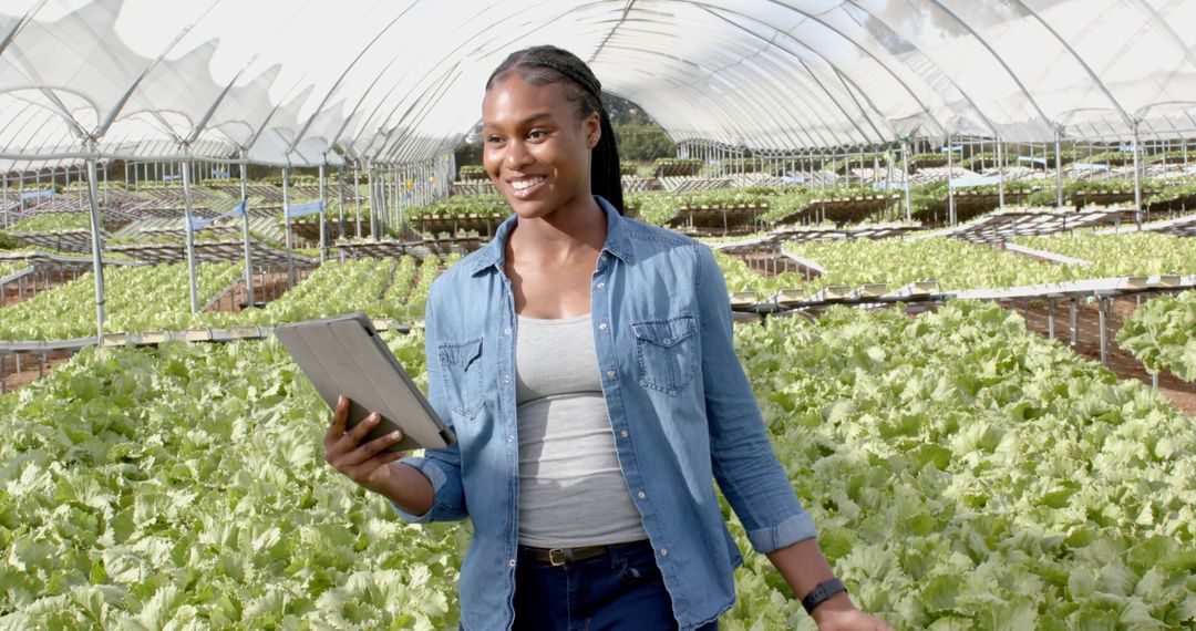 Woman Using Tablet in Hydroponic Greenhouse for Smart Farming