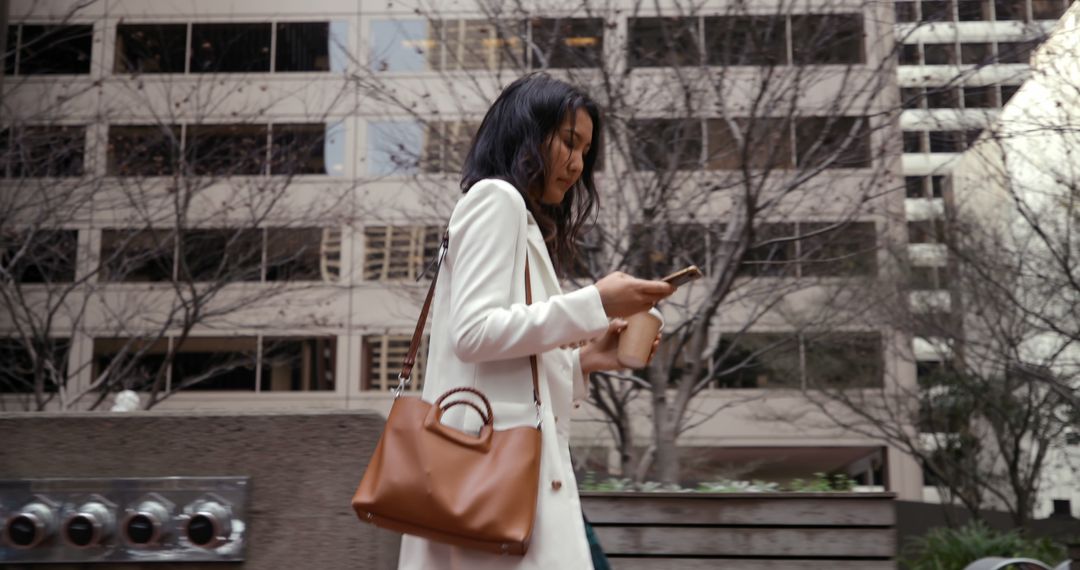 Businesswoman Walking in the City Using Smartphone - Free Images, Stock Photos and Pictures on Pikwizard.com