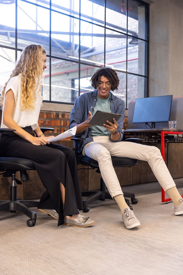 Diverse Coworkers Collaborating in Modern Loft Office Environment